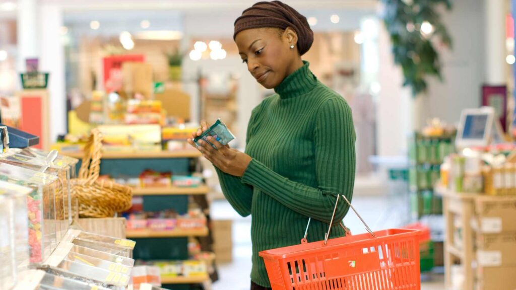 femme qui analyse un produit au super marché